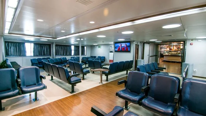 Indoor passenger lounge aboard a Caremar ferry